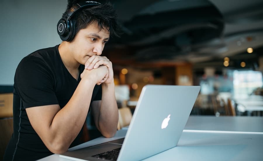 Person studying with a laptop and notebook at a desk